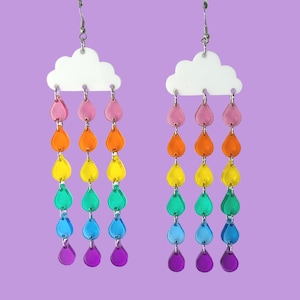May include: Rainbow cloud earrings with a white cloud charm and a dangling chain of colorful raindrops.