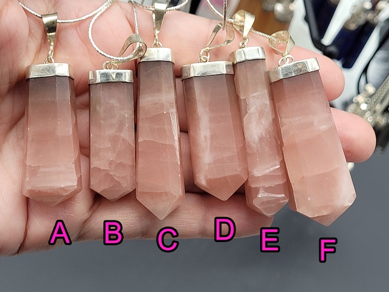 May include: Six pink crystal pendants with silver settings, labeled A through F.