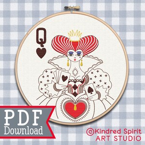 May include: Embroidered design of the Queen of Hearts from Alice in Wonderland. The design features a red heart, a crown, and a playing card. The design is in a circular hoop.