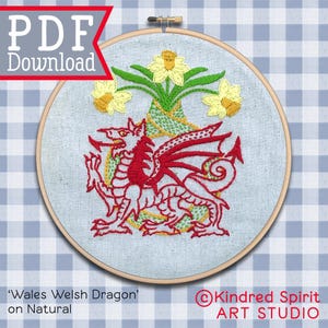 May include: Embroidered hoop art featuring a red Welsh dragon and yellow daffodils. The design includes the text "PDF Download" and "Wales Welsh Dragon on Natural". The artwork is set against a light blue fabric.