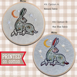 May include: Two embroidery kits featuring a stylized grey rabbit with a crescent moon and stars. The kits are available in natural fabric and mist blue fabric.