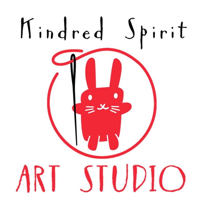 May include: A red circle with a red bunny holding a black needle and thread. The text "Kindred Spirit Art Studio" is written in black above and below the circle.