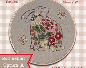May include: Embroidered hoop art featuring a red rabbit with floral details. The hoop is 8.5 inches in diameter and the fabric is natural linen. The design is titled "Red Rabbit Option A" and is by Kindred Spirit Art Studio.