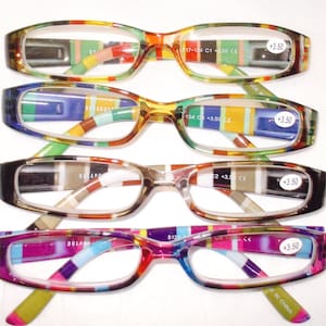 May include: Four pairs of reading glasses with colorful striped frames. Each pair has a different color scheme, including red, blue, green, and purple. The lenses have a magnification of +3.50.