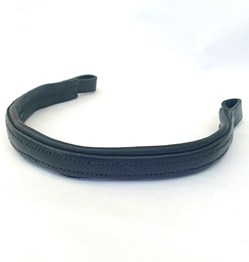 May include: A black leather browband for a horse bridle. The browband has a stitched design.