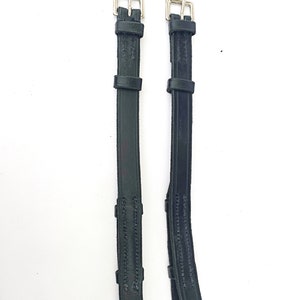 May include: Two black leather stirrup leathers with silver buckles.