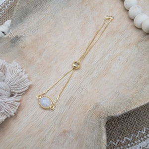 Moonstone shown in different lighting to show flashes of blue.