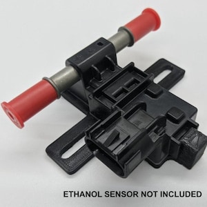 May include: A black fuel pump with red fuel lines and a black electrical connector. The text "ETHANOL SENSOR NOT INCLUDED" is printed below the pump.