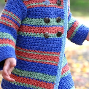 May include: A blue, green, and orange striped crocheted cardigan with a blue collar and metal buttons.