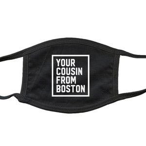 May include: Black face mask with white text that reads "Your cousin from Boston".