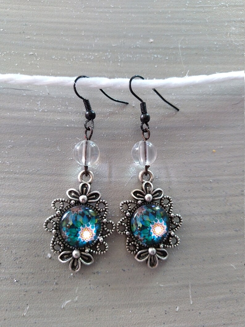 Fancy cabochon earrings with blue and green floral motof transparent pearl silver metal