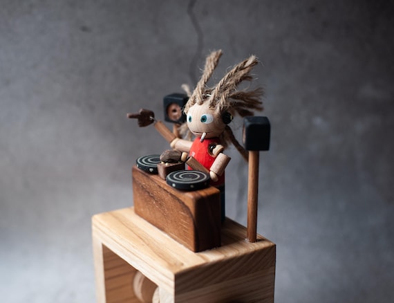 A handcrafted wooden DJ automaton that actually scratches — a genuinely hilarious and one-of-a-kind gift for any music head.
