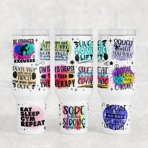 May include: Set of six white tumblers with colorful watercolor designs and motivational fitness quotes. The quotes include "Be Stronger than your Excuses", "Gym is Cheaper than Therapy", "Live Love Lift", "Squat until you walk funny", "Eat Sleep Gym Repeat", and "Sore today Strong tomorrow".