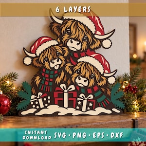May include: A multi-layered wooden wall art piece featuring three Highland cows wearing red and white Santa hats and striped scarves. The cows are positioned above three gift boxes with bows, set against a snowy base. Text reads 6 LAYERS.