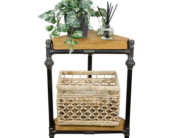 May include: A black metal industrial style corner shelf with two wooden shelves. The top shelf has a potted plant with green leaves and a glass bottle with black sticks. The bottom shelf has a woven basket.