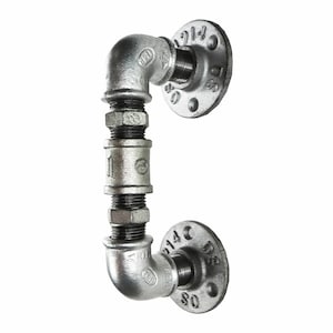 May include: A silver metal door handle made from industrial pipe fittings. The handle is shaped like a 'D' and has two flanges on either end.
