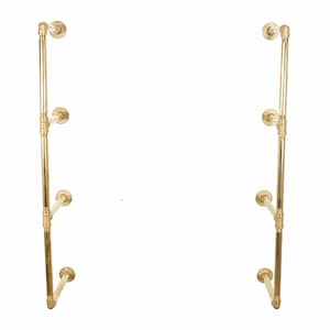 May include: A gold metal pipe shelf unit with three shelves. The shelf unit is mounted to a wall.