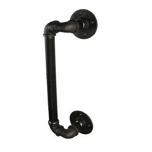 May include: Black industrial-style door pull handle. The handle is made of black metal pipes and fittings, with two round mounting plates. The handle has a curved design, suitable for a rustic or modern aesthetic.