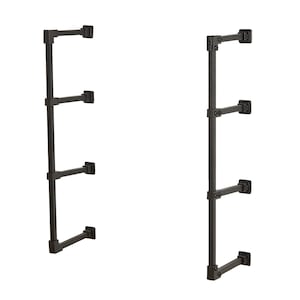 May include: Black metal shelf unit with three shelves. The shelves are attached to a vertical support pole with brackets. The unit is designed to be mounted to a wall.