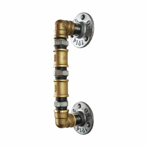 May include: Gold and silver industrial pipe door handle with a 1/2 inch pipe fitting. The handle is made of metal and has a rustic look.