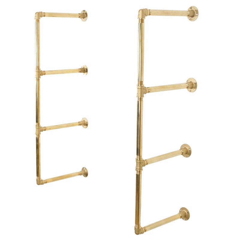 May include: A gold metal shelf unit with four shelves. The shelves are made of pipe and have a rustic industrial look.