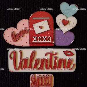 May include: A Valentine's Day themed craft project with a red mailbox, hearts, and the words "XOXO", "Cutie", "Love", "Be Mine", "I Love You", and "Valentine".