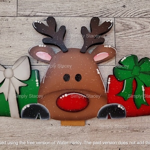May include: A wooden reindeer figurine with a red nose and brown antlers. The reindeer is holding two presents, one green with a white bow and one red with a green bow.