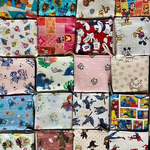 Pu&ograve; includere: Una collezione di piccole pochette quadrate in tessuto con varie stampe di personaggi dei cartoni animati, tra cui Paw Patrol, Topolino e supereroi. Ogni pochette ha un anello per appenderla e presenta un motivo e una combinazione di colori unici.