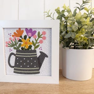 May include: A white ceramic mug with a black handle and the text "But First, Coffee" in a handwritten style. The mug is on a white surface. The mug is approximately 4 inches tall.