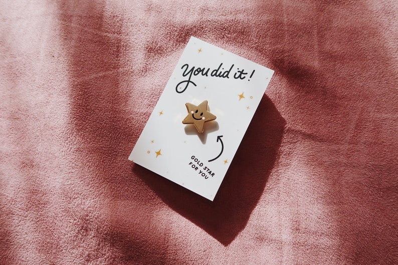 A white card with the text "You did it!" and a gold star with a smiley face. The card also says "Gold Star for You".