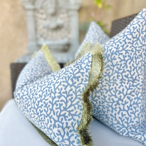 Blue coral outdoor pillow cover with green brush fringe detail , coastal outdoor pillows for outdoor sitting, decorative outdoor pillows