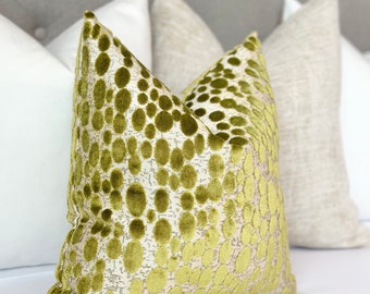 May include: Two decorative throw pillows with a green and white patterned design. The pillow on the left has a large, abstract, green and white pattern. The pillow on the right has a smaller, more subtle, green and white pattern.