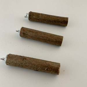 May include: Three brown wooden sticks with metal caps on the ends. The sticks are approximately 15 cm long and are arranged in a row.