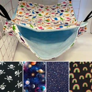 May include: A blue and white fabric hanging bed for small pets, with a dinosaur print. The bed is suspended from the ceiling of a cage. The image also shows four different fabric patterns: skulls, planets, constellations, and rainbows.