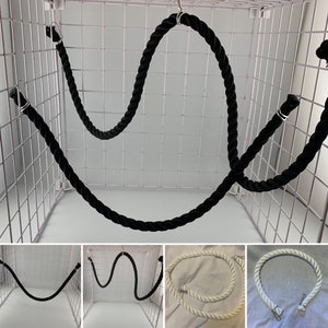 Black rope pet toy suitable to hang in cage. The rope is in a curved shape and is attached to the cage with metal hooks. The rope is also shown in different colours white, natural and black.