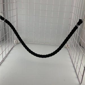 Black rope pet toy suitable to hang in cage. The rope is in a curved shape and is attached to the cage with metal hooks.