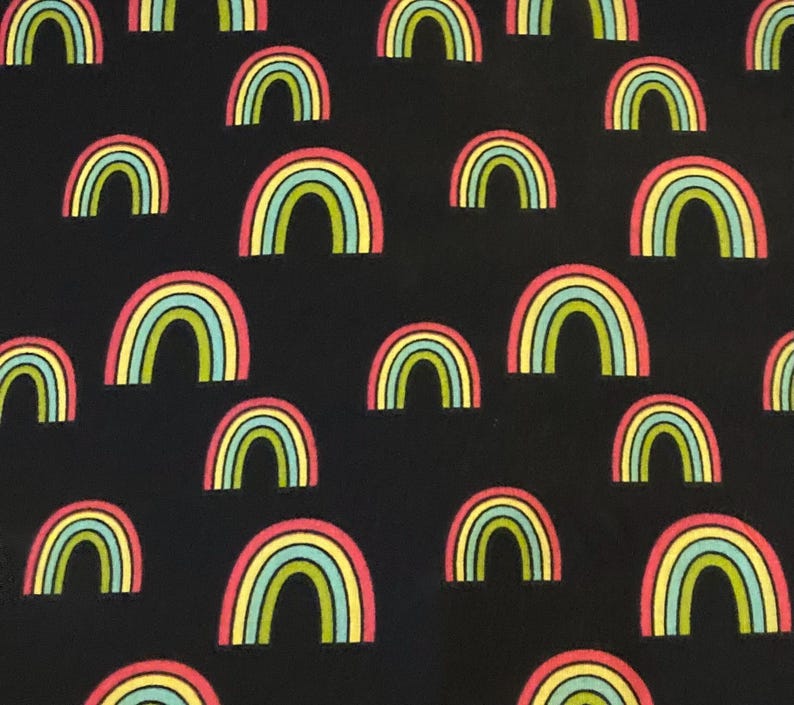 May include: Black fabric with a repeating pattern of colorful rainbows. The rainbows are outlined in yellow, green, blue, and pink.