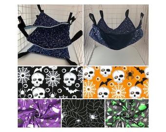 May include: A set of six different Halloween-themed fabric patterns featuring skulls, spiderwebs, bats, and eyeballs. The patterns are in black, white, orange, and green.