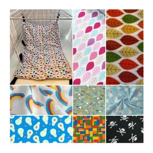 May include: A collection of fabric swatches with various patterns, including rainbows, leaves, avocados, and skulls. The fabrics are in a variety of colors, including pink, blue, green, yellow, and black.