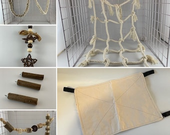 May include: A set of pet cage accessories including a rope hammock, a rope ladder, a wooden chew toy, and a beige canvas hammock.