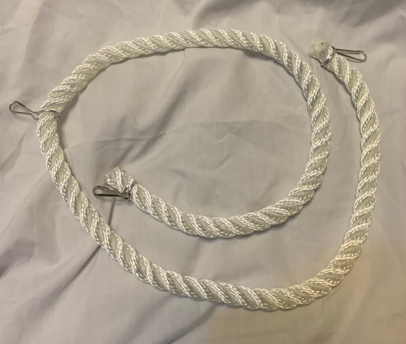 white rope pet toy suitable to hang in cage. The rope is in a curved shape and is attached to the cage with metal hooks.
