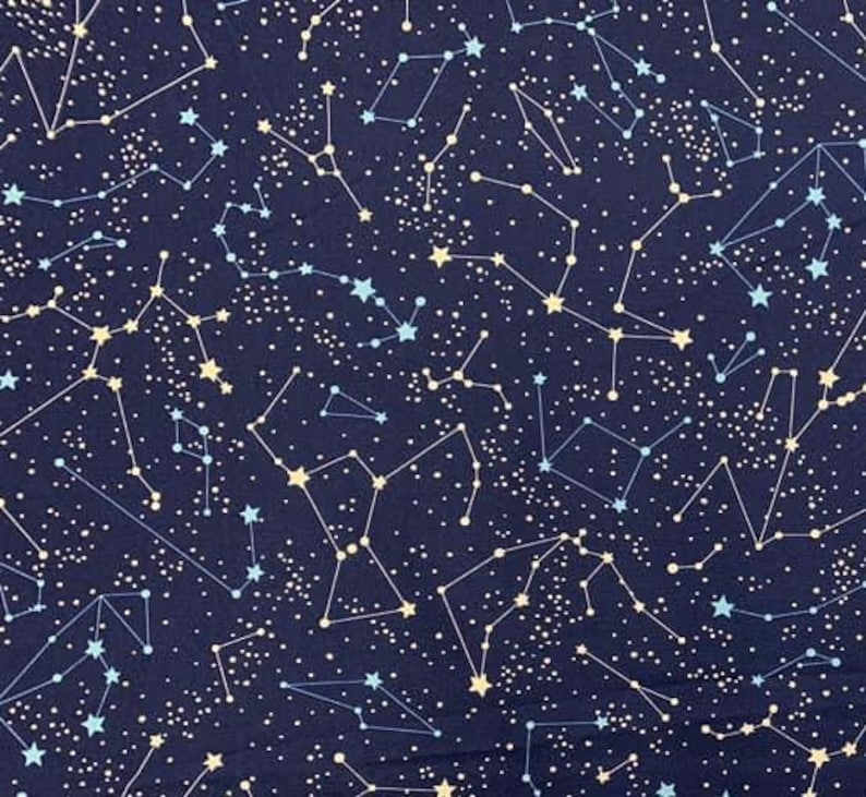 May include: A navy blue fabric with a constellation pattern. The constellations are made of white and light blue lines and dots. There are also small white stars scattered throughout the fabric.