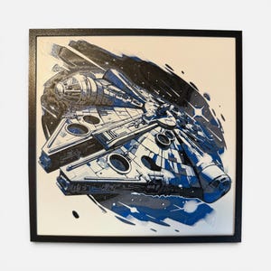 May include: A square framed wall art piece featuring a detailed illustration of a starship in shades of blue, black, and white. The artwork depicts the vessel angled against a dark, abstract space background with star-like accents and ink-style strokes.