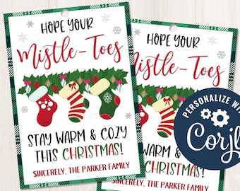 May include: A printable Christmas gift tag with a green and red plaid background. The tag features a festive illustration of three Christmas stockings with the text "Hope your mistle-toes stay warm & cozy this Christmas!" and "Sincerely, The Parker Family".