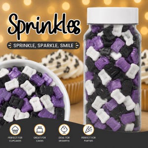 May include: A clear plastic jar filled with purple, black, and white sprinkles. The sprinkles are shaped like small rectangles. The jar has a white lid. The word "Sprinkles" is written in a decorative font above the jar. The text "SPRINKLE, SPARKLE, SMILE" is also visible.