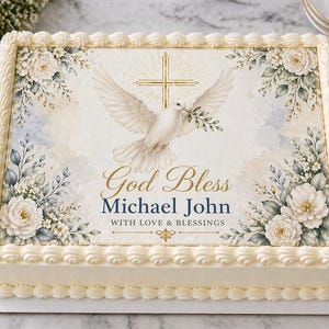 May include: A rectangular cake with white frosting and decorative border. The cake features a printed image of a white dove carrying an olive branch, a gold cross, and floral arrangements. The text reads "God Bless Michael John WITH LOVE & BLESSINGS."