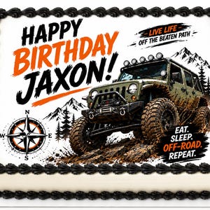May include: A rectangular cake with black frosting trim and a white top. The cake features a graphic of a green off-road vehicle, mountains, and a compass. Text includes "Happy Birthday Jaxon!" and "Eat. Sleep. Off-Road. Repeat."