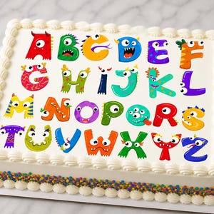 May include: A rectangular cake decorated with the alphabet, each letter designed as a colorful monster. The cake has white frosting, a decorative border, and a sprinkle-covered base. Perfect for a birthday or celebration.