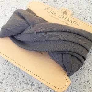 May include: A gray knitted headband with a brown cardboard tag that says "PURE CHAKRA Live Hippie. Live Free."