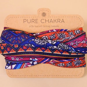 May include: A colorful patterned headband with a brown cardboard tag that reads "PURE CHAKRA A Be Yourself Clothing Company".